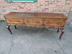 A GEORGIAN OAK DRESSER, with three drawers, crossbanded detailing, raised on cabriole legs, H 83 cm,