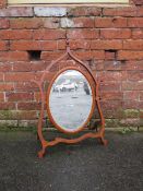 A LATE 19TH CENTURY MAHOGANY DRESSING MIRROR, the oval mirror supported on a shaped framed, H 76 cm