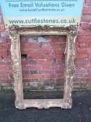 A 19TH CENTURY GILT RECTANGULAR PICTURE FRAME, in distressed finish, with plaster moulded detail,