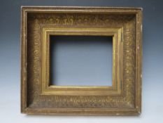 AN 18TH CENTURY GOLD HINGED CABINET FRAME, with acanthus leaf design, frame W 11 cm, rebate 25 x