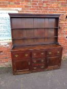 AN 18TH CENTURY OAK WELSH DRESSER, the base with an arrangement of five drawers and two cupboards,