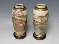 A PAIR OF JAPANESE VASES, decorated with typical scenes, with wooden stands and box, marks to