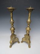 A PAIR OF DECORATIVE BRASS PRICKET CANDLESTICKS, with cherubic mask detail, H 43 cm (2)