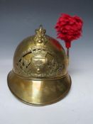 A 19TH CENTURY FRENCH BRASS FIREMANS HELMET, with Sapeurs Pompiere Montrevil badge and side plume