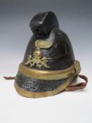 A VICTORIAN MERRYWEATHER LEATHER FIREMANS HELMET, with brass banding and head badge