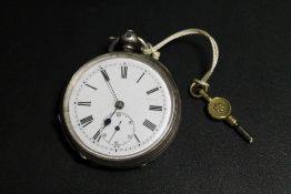 AN ANTIQUE SILVER CASED POCKET WATCH WITH KEY