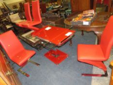 A MODERN GLASS KITCHEN TABLE WITH FOUR RED CHAIRS