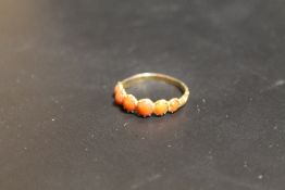 A VICTORIAN RING SET WITH CORAL STONES