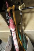 A SMALL COLLECTION OF WALKING STICKS AND UMBRELLAS TO INCLUDE A SHOOTING STICK
