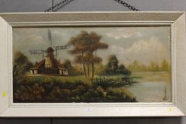 A FRAMED OIL ON CANVAS OF A WINDMILL SCENE SIGNED LOWER RIGHT K.P.DOWNER