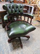 A GREEN LEATHER SWIVEL OFFICE ARMCHAIR