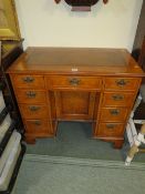 A REPRODUCTION WALNUT LEATHER TOPPED KNEEHOLE DESK H-82 W-93 CM NOTE - IN OFFICE