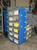 A ROTATING STORAGE CAROUSEL CONTAINING VARIOUS SYRINGES, ROTARY CUTTERS, BUTTONS ETC