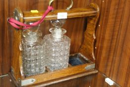 AN OAK TANTALUS WITH TWO DECANTERS