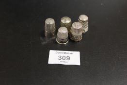 FIVE WHITE METAL THIMBLES