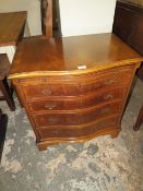 A REPRODUCTION MAHOGANY SERPENTINE CHEST OF FOUR DRAWERS WITH BRUSHING SLIDE