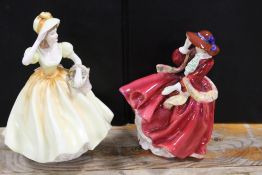 A ROYAL DOULTON TOP O' THE HILL FIGURE TOGETHER WITH A COALPORT AMY FIGURINE (2)