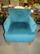 A MODERN UPHOLSTERED TEAL ARMCHAIR