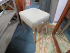A MODERN UPHOLSTERED GREY STOOL