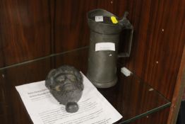 A CAST LEAD 'MASK OF AESCULAPIUS' TOGETHER WITH A PEWTER TANKARD (2)
