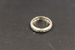 A VINTAGE 9CT GOLD AND SILVER ETERNITY RING
