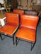 A SET OF FOUR TAN LEATHER INDUSTRIAL STYLE DINING CHAIRS