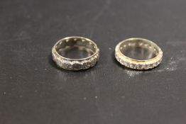 TWO 9CT GOLD AND SILVER ETERNITY RINGS