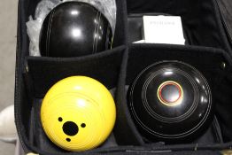 A CASED SET OF HEMSELITE BIASE TWO FULL CROWN CONQUEST TWIN RING BOWLS AND JACK