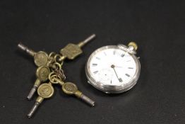 A SMALL FOB WATCH TOGETHER WITH A SELECTION OF POCKET WATCH KEYS