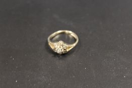 A 9CT GOLD CLUSTER RING SET WITH DIAMONDS