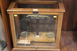 A CASED SET OF LABORATORY SCALES WITH CASED SET OF WEIGHTS