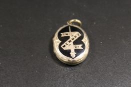 A VICTORIAN ENAMELLED MOURNING LOCKET