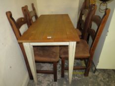 A MODERN DINING TABLE WITH FOUR CHAIRS