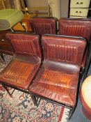 A SET OF FOUR TAN LEATHER INDUSTRIAL STYLE DINING CHAIRS