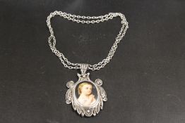 A LARGE ANTIQUE FILIGREE SILVER PENDANT AND CHAIN CONTAINING MINIATURE