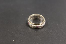 A VINTAGE 9CT GOLD AND SILVER ETERNITY RING