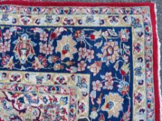 A LARGE RUG, CREAM GROUND WITH RED AND BLUE, APPROX 368 X 270 - WEAR THROUGHOUT