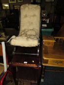 AN EDWARDIAN EBONISED SLIPPER STOOL AND A MAHOGANY TROLLEY (2)