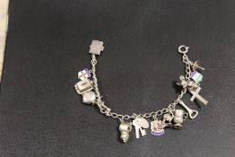 A VINTAGE SILVER CHARM BRACELET WITH 15 CHARMS