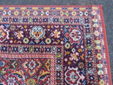 A LARGE CARPET - RUST / TERRACOTTA GROUND WITH NAVY / YELLOW PATTERN, APPROX 365 X 253 CM - WEAR