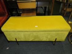 A MODERN YELLOW UPHOLSTERED OTTOMAN