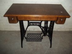 AN ANTIQUE SINGER CAST IRON AND OAK TABLE