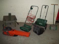 A SELECTION OF GARDEN TOOLS TO INCLUDE A FLYMO LEAF VAC AND A QUALCAST POWERED RAKE AND WHEELBARROW