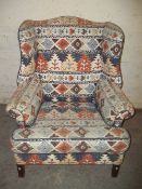 A WING BACK FIRESIDE CHAIR