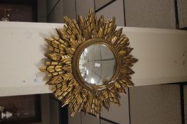 A ROUND STAR BURST MIRROR WITH GILT FRAME