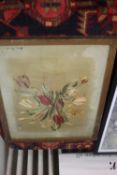 A FRAMED AND GLAZED SILK DEPICTING FLOWERS