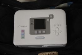 A CASED CANNON SELPHY