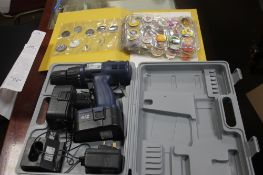 A BUDGET ELECTRIC DRILL IN CASE TOGETHER WITH A FOLDER OF BUTTON BADGES