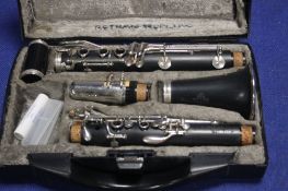 A BUFFET CLARINET IN CASE ALONG WITH 2 MUSIC STANDS