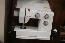 A CASED RICCAR ELECTRIC SEWING MACHINE